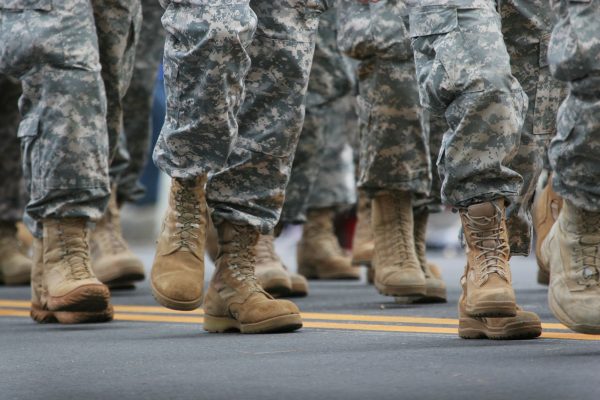 the feet of walking military troops