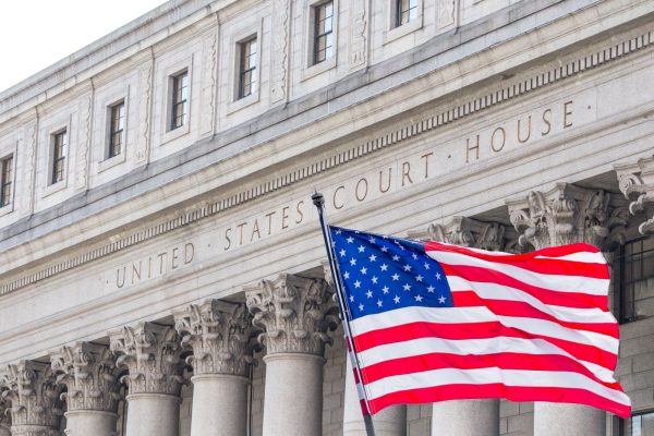 U.S. flag waving in the wind in front of United States Court House