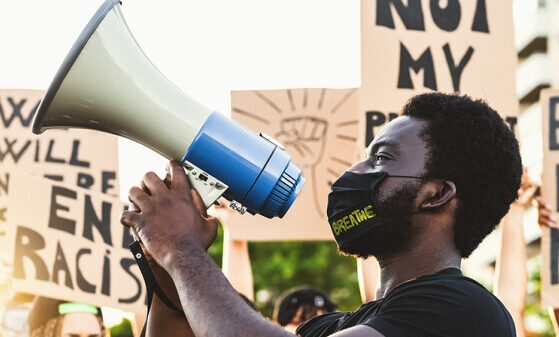 Black person holding a megaphone