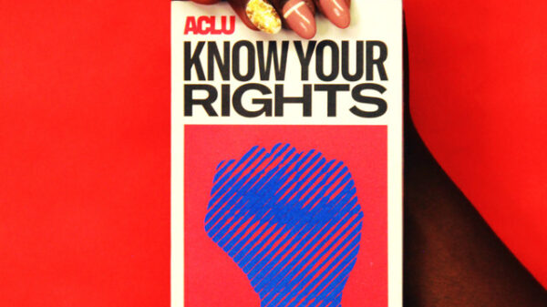 person holding a book that says Know Your Rights