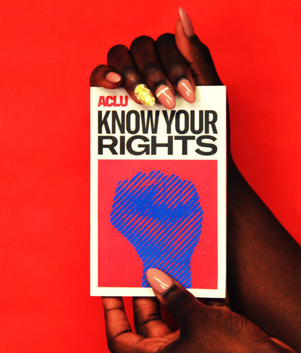 person holding a book that says Know Your Rights