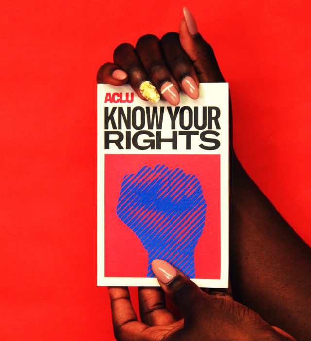 person holding a book that says Know Your Rights