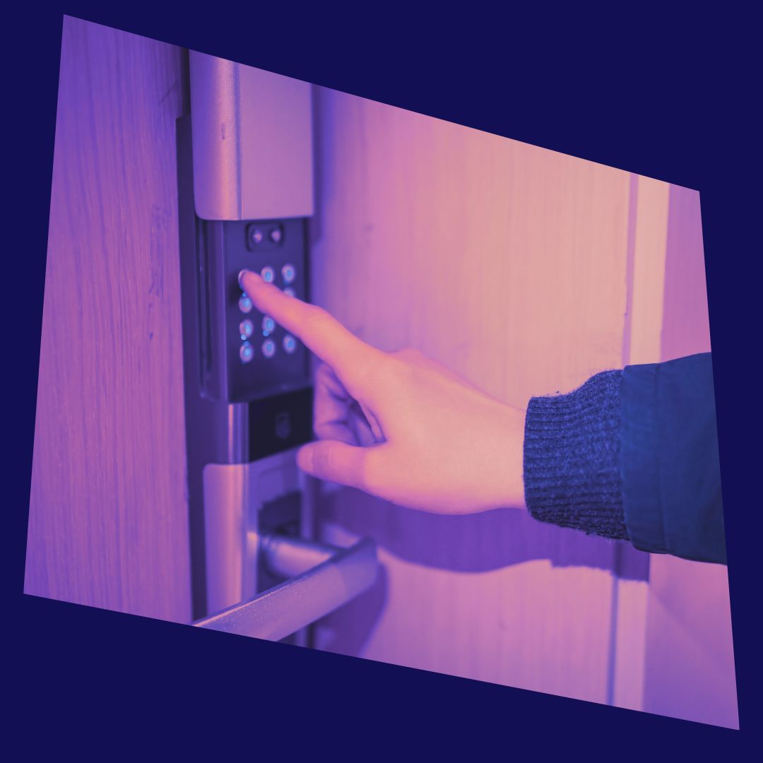 A hand pressing button on a digital door lock