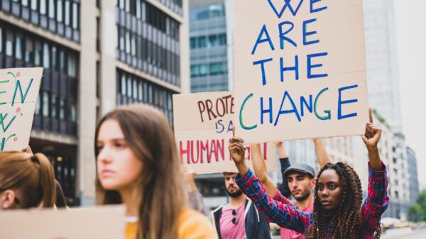 Amid a protest, one person carries a sign that read "We are the change"