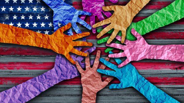 Art piece of different color hands coming together over an American flag