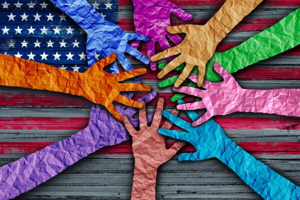 Art piece of different color hands coming together over an American flag