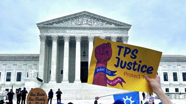 Supreme Court facade with activist holding sign saying "TPS Justice"