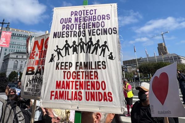 A protest sign reading, "Protect our neighbors, keep families together."