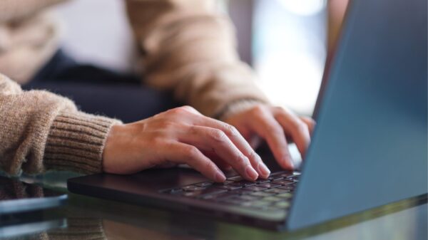 hands typing on a laptop