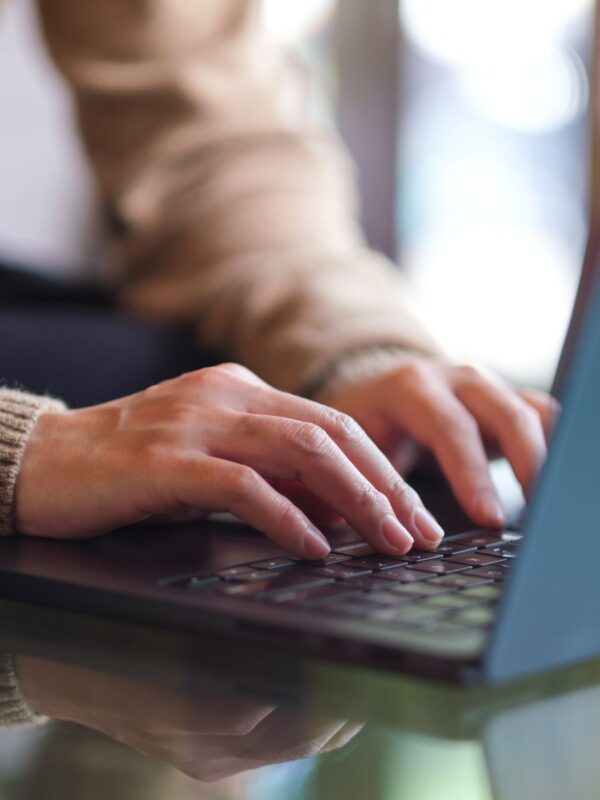 hands typing on a laptop