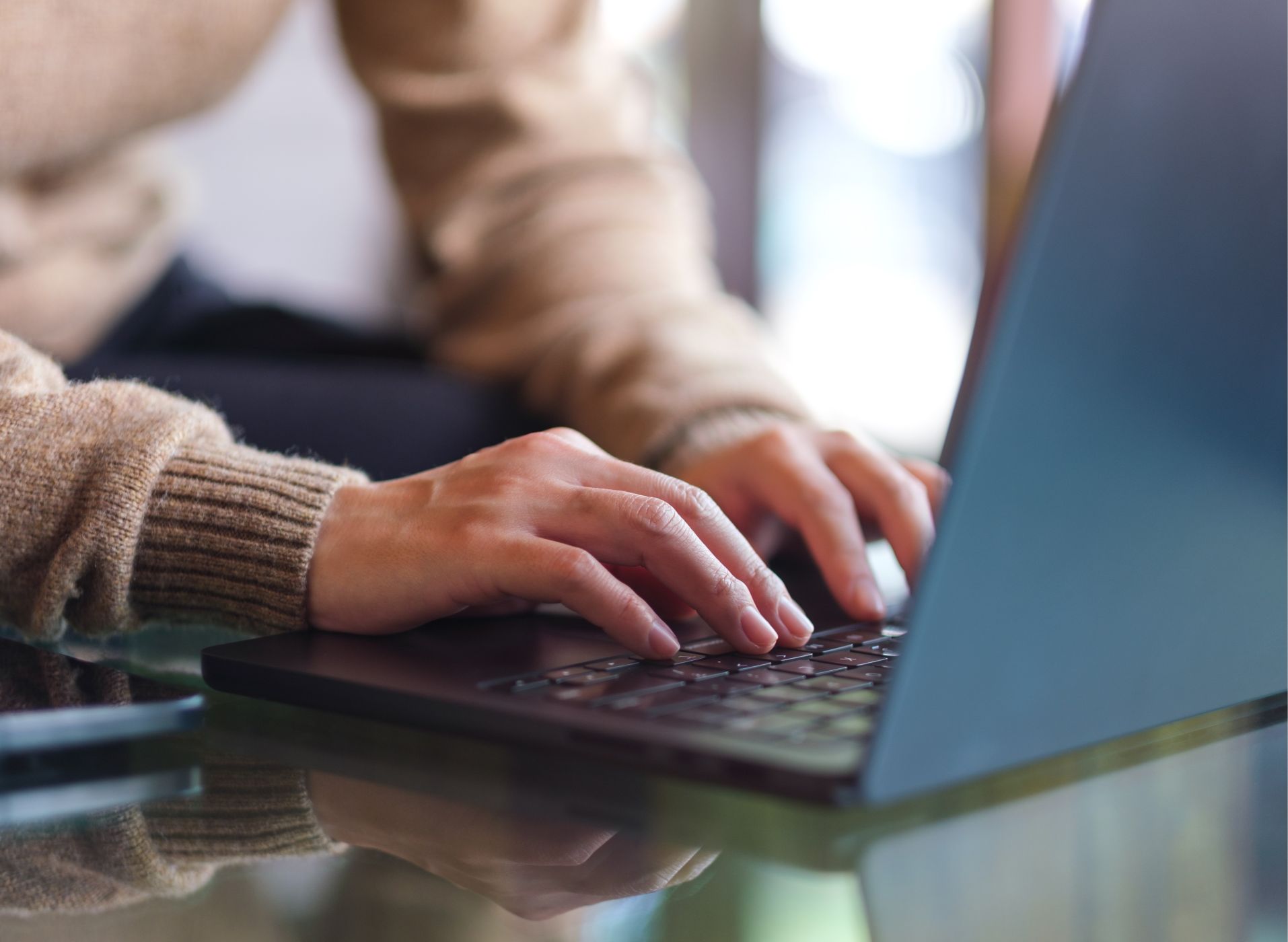 hands typing on a laptop