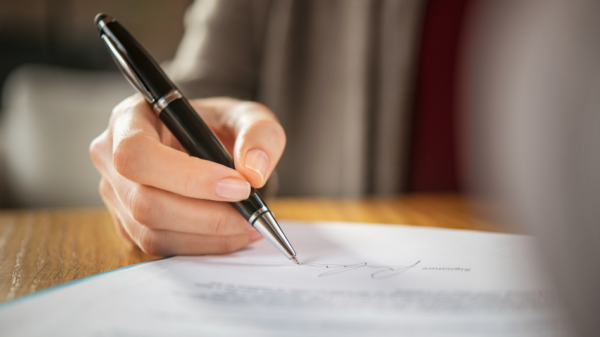 Person penning a letter