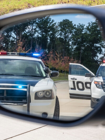 Police cars in rearview mirror