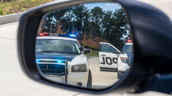 Police cars in rearview mirror