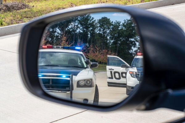 Police cars in rearview mirror