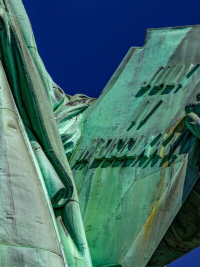 Photo of the hand of the Statue of Liberty holding the book of the American Declaration of Independence