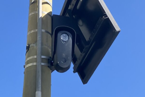 Photo of a Flock license plate reader camera on a light pole in San Francisco.