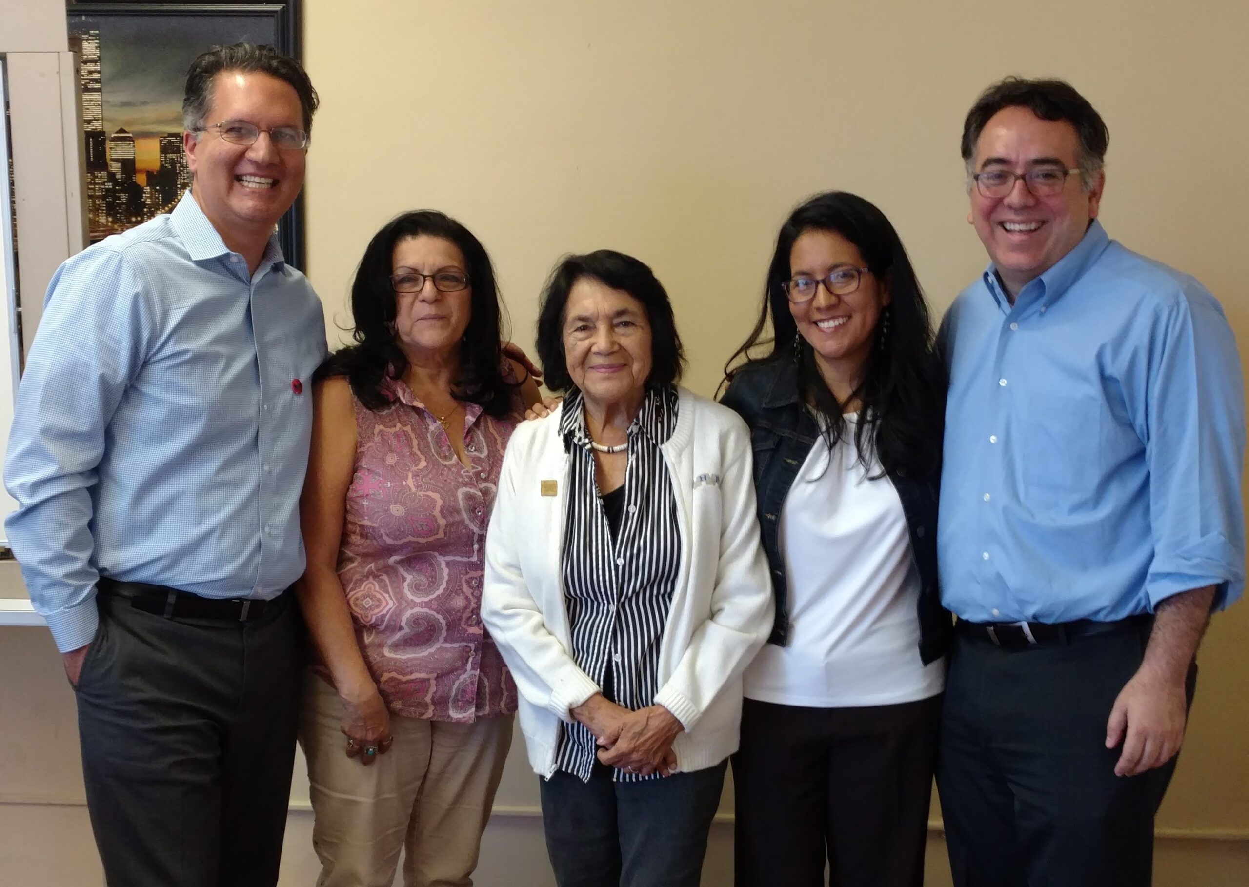 Dolores Huerta joins ACLU NorCal Executive Director Abdi Soltani, far left, and ACLU SoCal then-Executive Director Hector Villagra, far right, to celebrate the opening of the ACLU's Kern County office in October 2017.